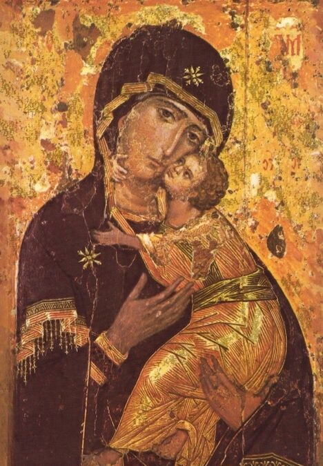 An ancient religious icon, Theotokos of Vladimir, depicts the Virgin Mary holding the infant Jesus. Both are dressed in ornate robes with gold accents, and the background is gold with visible aging and wear. Jesus leans affectionately toward Mary.